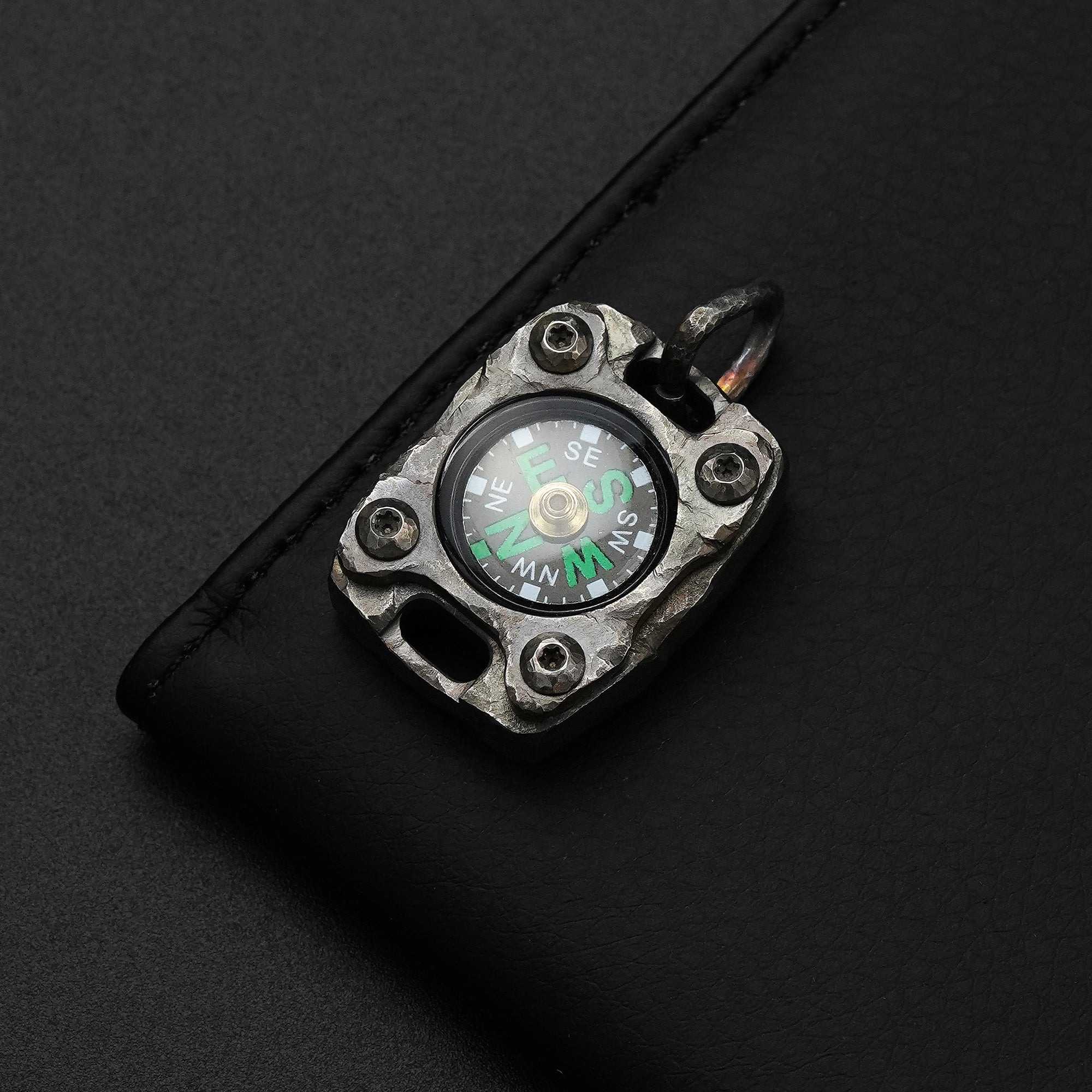Front view of the MecArmy CMP2-HC hand-carved titanium EDC compass with one-of-a-kind sculpted titanium texture