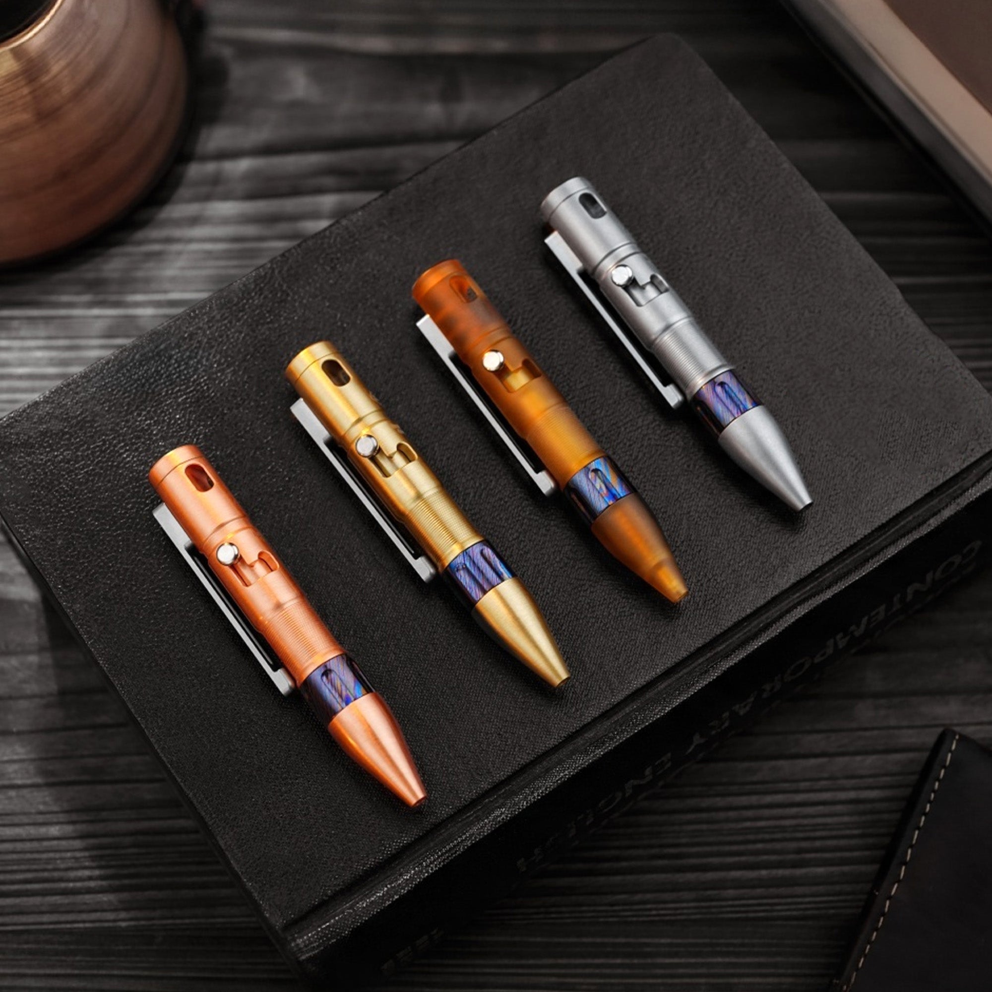 TPX11 pens in copper, brass, PEI, and titanium fitted with zirconium Damascus grips.