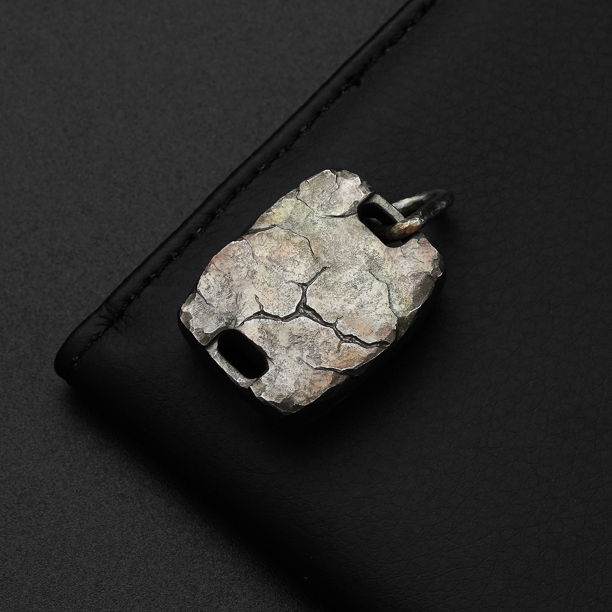 Back view of the MecArmy CMP2-HC hand-carved titanium EDC compass showing the unique cracked rock-like surface texture