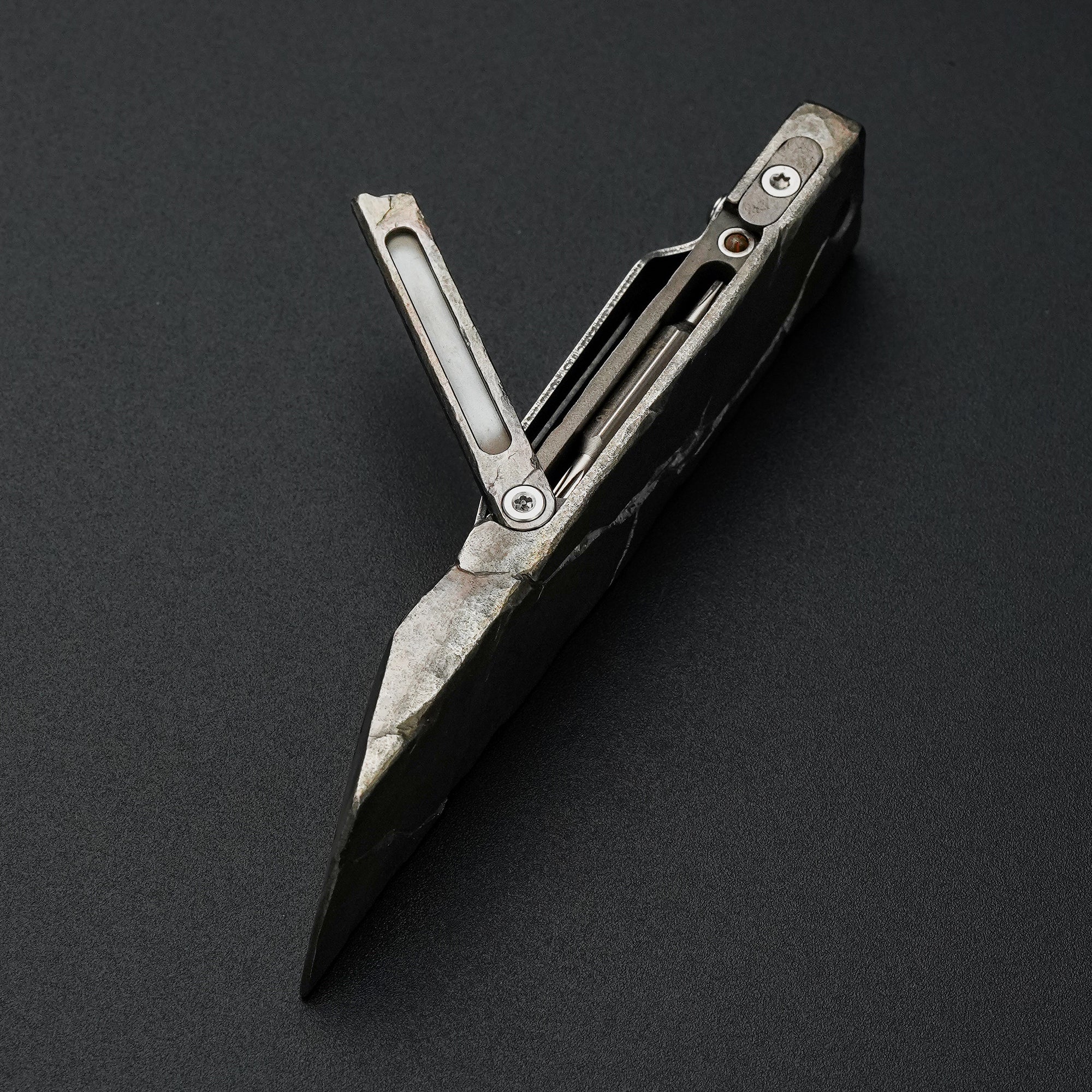MecArmy RL4-HC hand-carved titanium EDC pry bar with cracked texture shown open with the integrated tool compartment