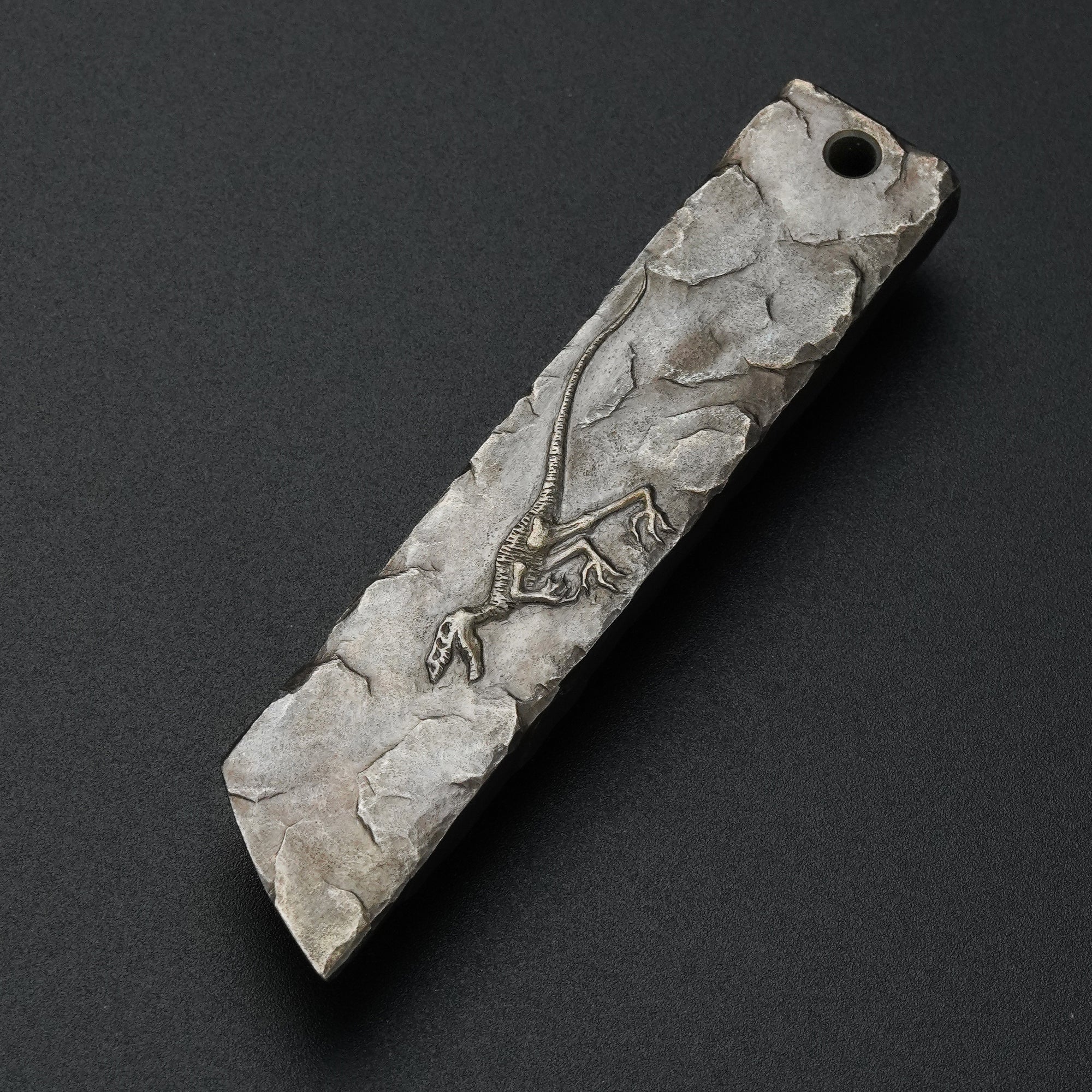 MecArmy RL4-HC hand-carved titanium EDC pry bar featuring a unique dinosaur skull carving on the sculpted titanium surface