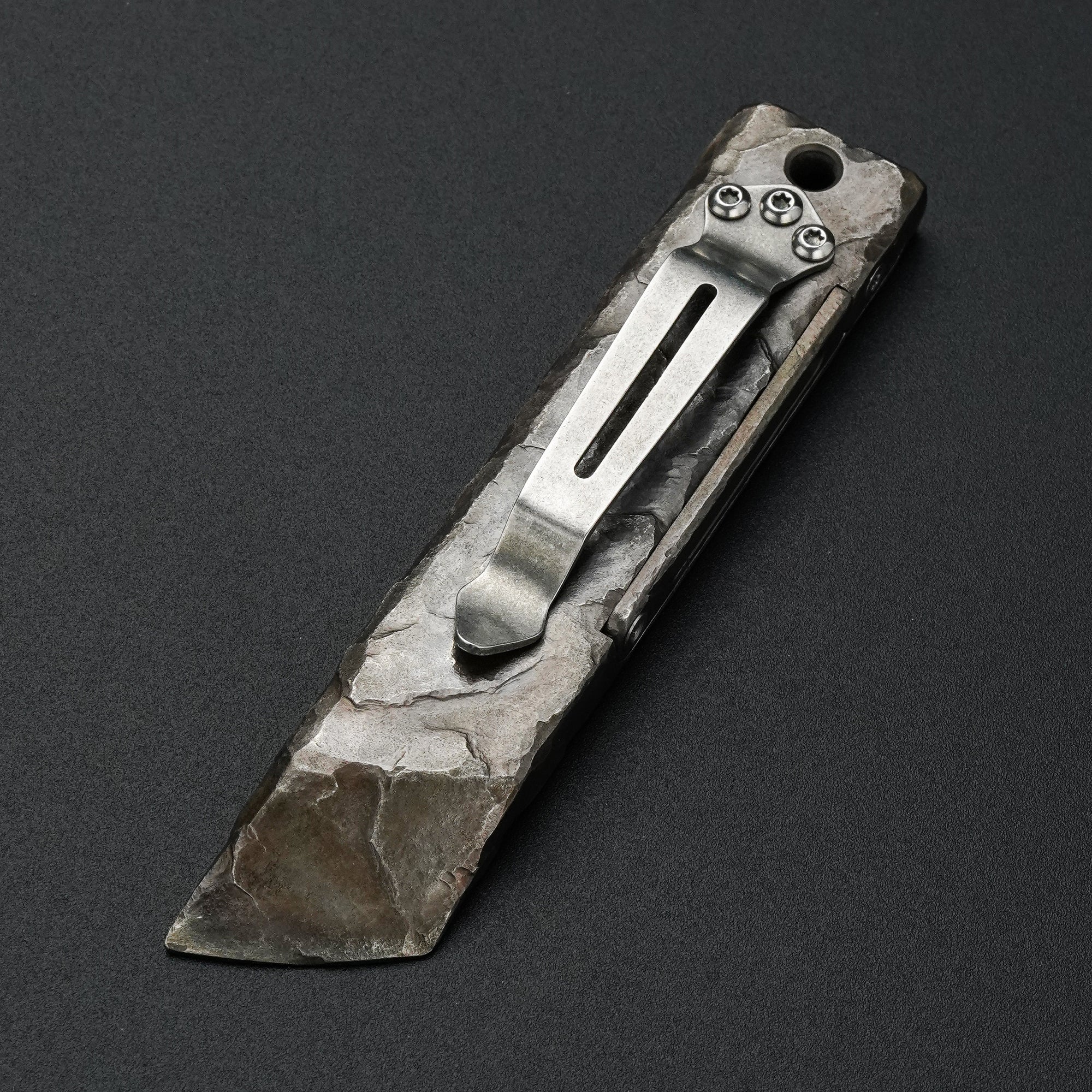 MecArmy RL4-HC hand-carved titanium EDC pry bar dinosaur skull edition showing the pocket clip and sculpted rock-like surface