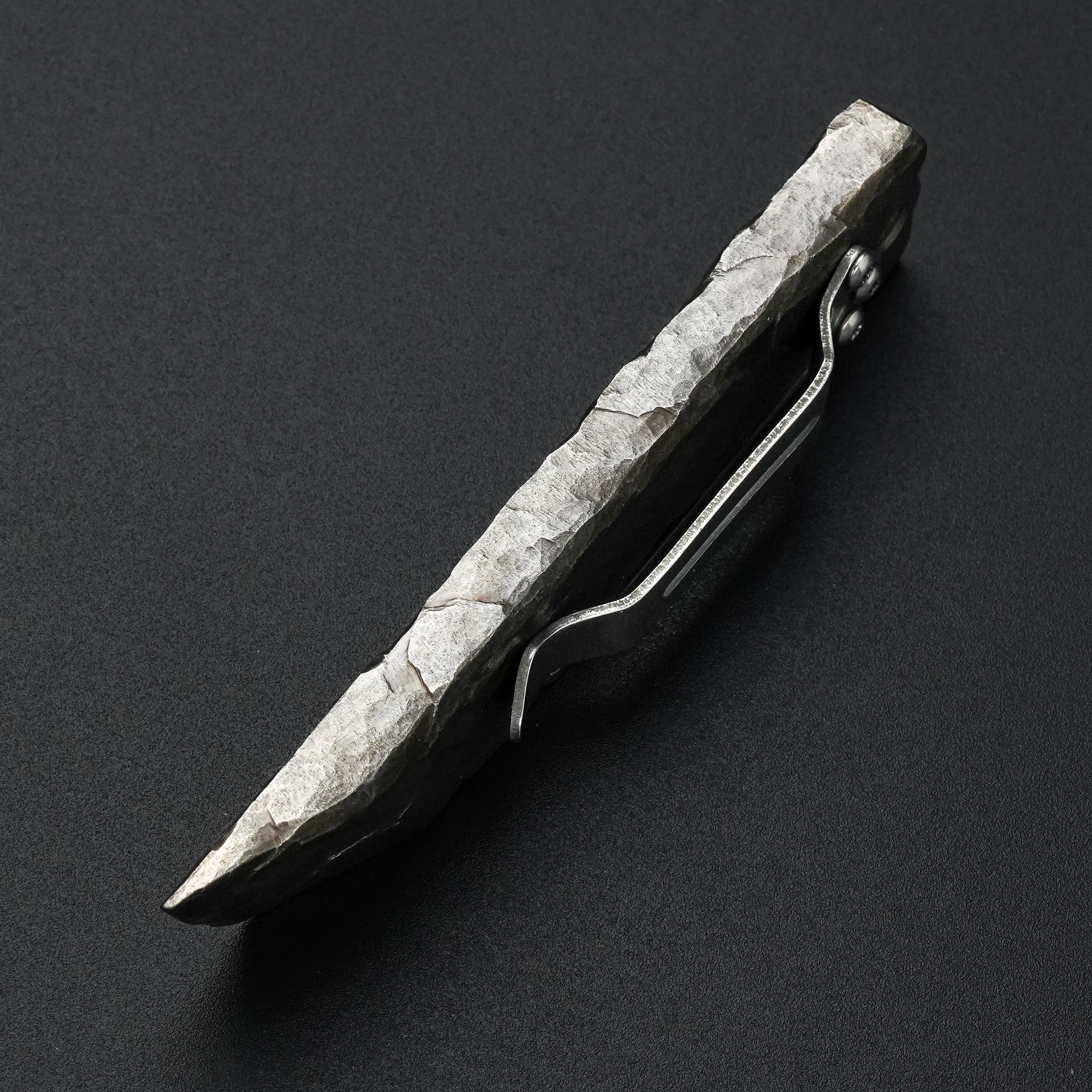 Side view of the MecArmy RL4-HC hand-carved titanium EDC pry bar with irregular sculpted edges and dinosaur skull detailing