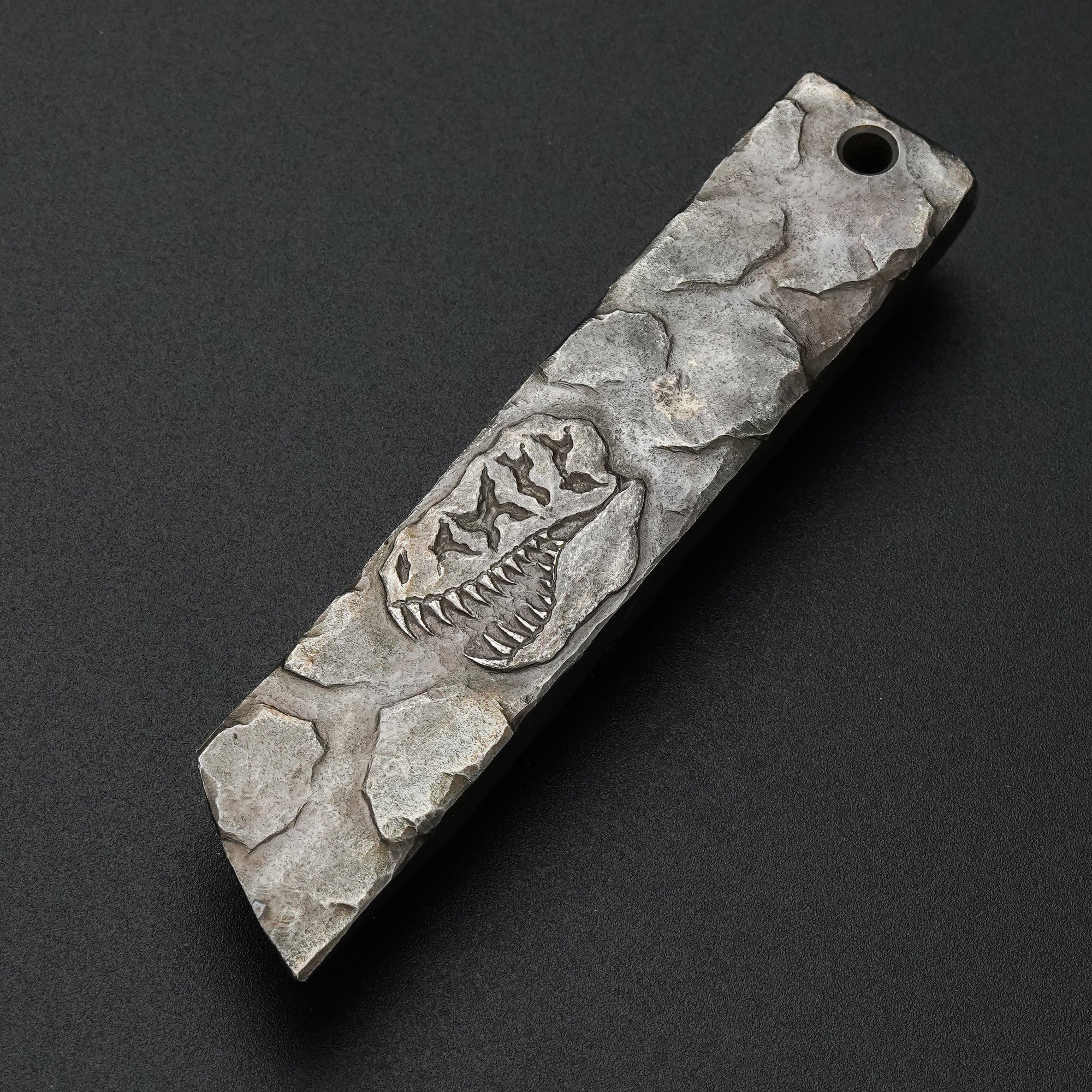 MecArmy RL4-HC hand-carved titanium EDC pry bar featuring a unique dinosaur skull carving on the sculpted titanium surface
