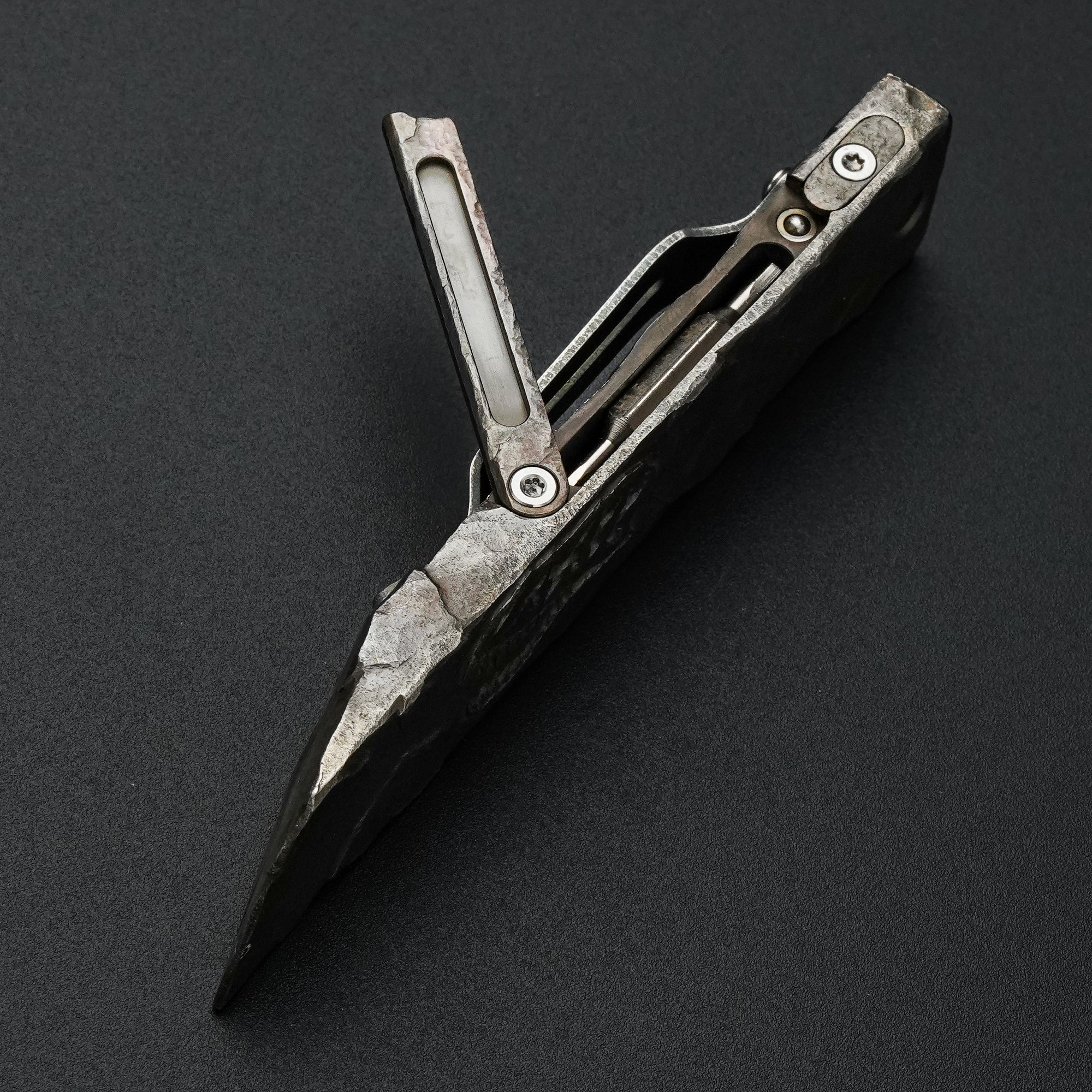 MecArmy RL4-HC hand-carved titanium EDC pry bar dinosaur skull edition shown open with the integrated tool compartment